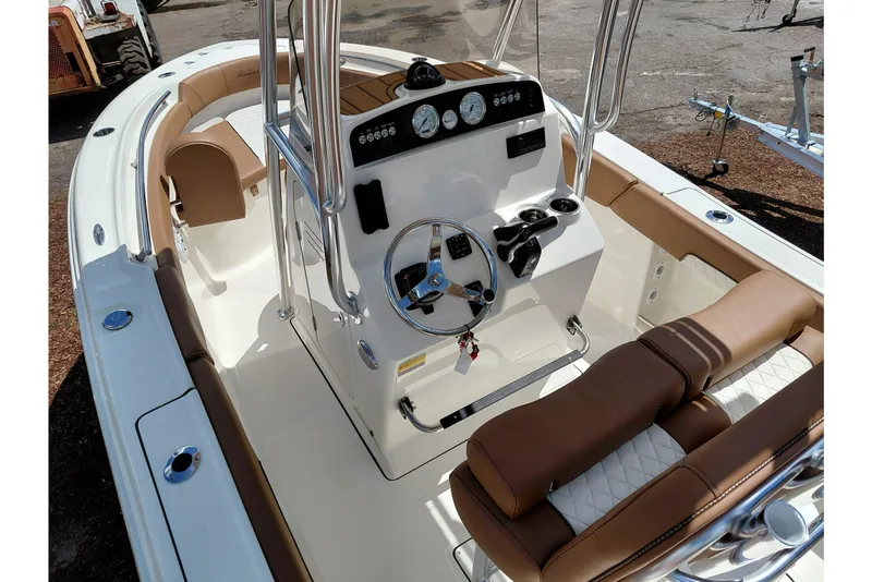 Slide: The Image of 2026 Pioneer 202 Islander boat interior with steering console and cushioned seating. - 45