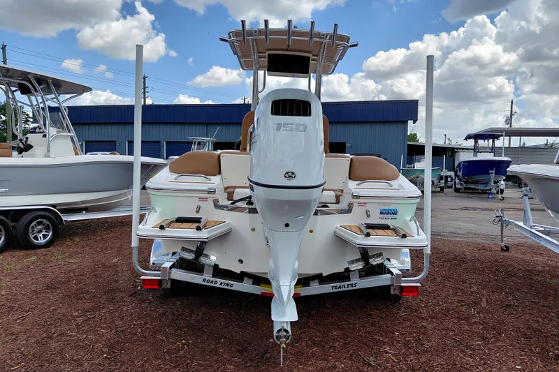 Slide: The Image of 2026 Pioneer 202 Islander boat with powerful outboard motor, displayed outdoors under cloudy sky. - 6