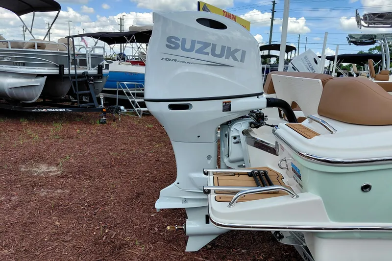 Slide: The Image of 2026 Pioneer 202 Islander boat with Suzuki outboard motor, displayed outdoors. - 8