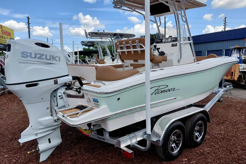 Slide: The Image of 2026 Pioneer 202 Islander boat with Suzuki engine on trailer, outdoor display. - 9