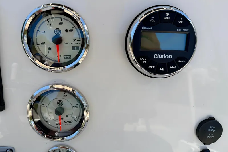 Slide: The Image of Dashboard of 2023 Key West 189 FS boat with gauges and Clarion audio system. - 12