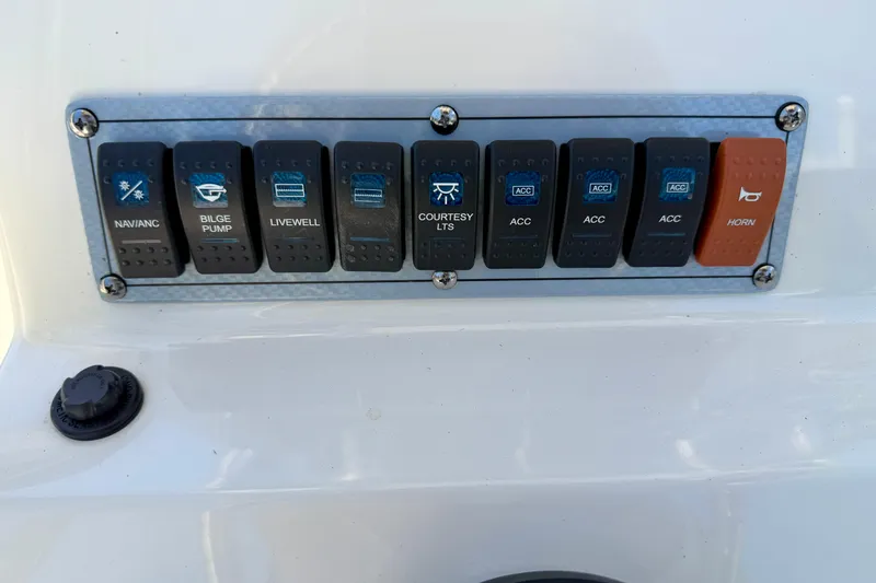 Slide: The Image of Control panel of 2023 Key West 189 FS boat with labeled switches. - 13