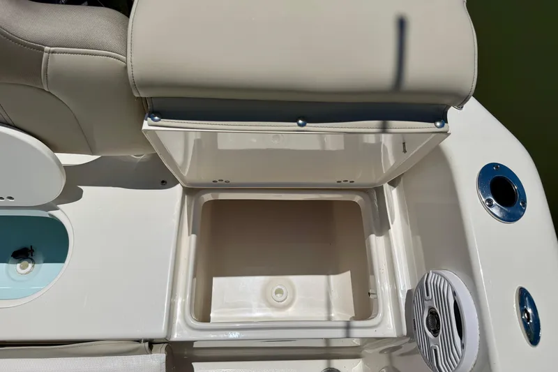 Slide: The Image of 2023 Key West 189 FS boat storage compartment with beige seating and cup holder. - 25