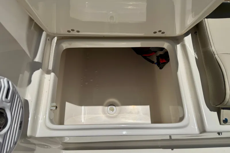 Slide: The Image of Storage compartment of 2023 Key West 189 FS boat, featuring spacious interior and secure latch. - 26