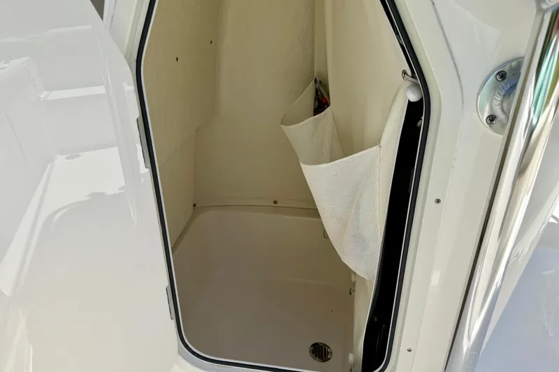 Slide: The Image of 2023 Key West 189 FS boat storage compartment with mesh pocket and drain. - 29