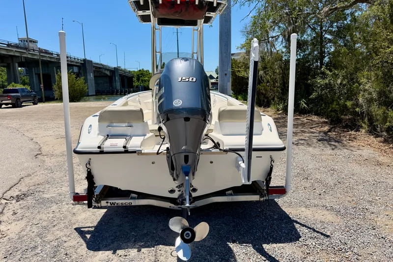 Slide: The Image of 2023 Key West 189 FS boat with Yamaha 150 engine, parked near a bridge. - 36