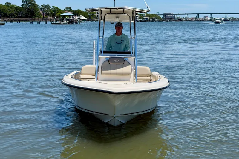 Slide: The Image of 2023 Key West 189 FS boat on calm water with a person at the helm. - 4