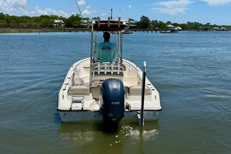 Slide: The Image of 2023 Key West 189 FS boat on calm water, rear view with outboard motor. - 5