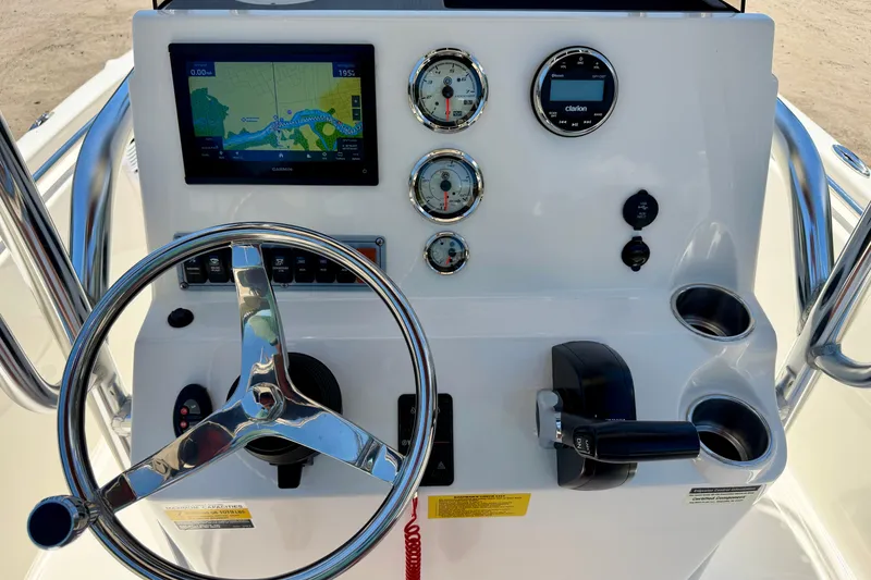 Slide: The Image of 2023 Key West 189 FS boat dashboard with steering wheel, gauges, and navigation display. - 9