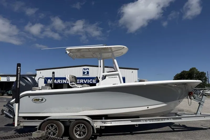 The Image of 2024 Sea Hunt Ultra 219 boat on trailer at marine service center. - 1