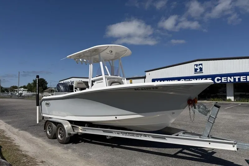 Slide: The Image of 2024 Sea Hunt Ultra 219 boat on trailer at marine service center. - 5