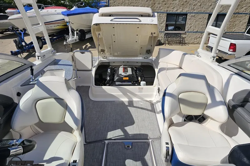 Slide: The Image of 2016 Chaparral 244 Sunesta boat interior with open engine compartment and seating area. - 103