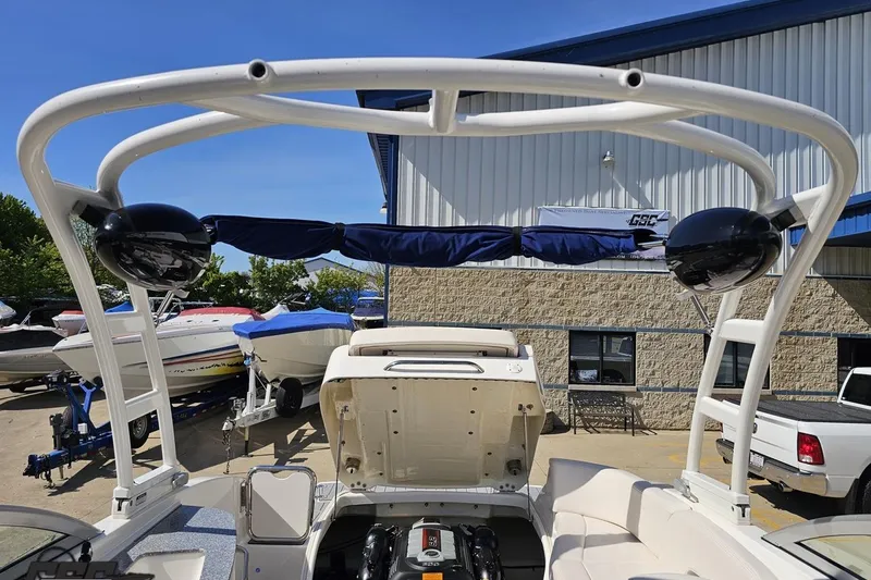Slide: The Image of 2016 Chaparral 244 Sunesta boat with open engine compartment, docked near other boats. - 104