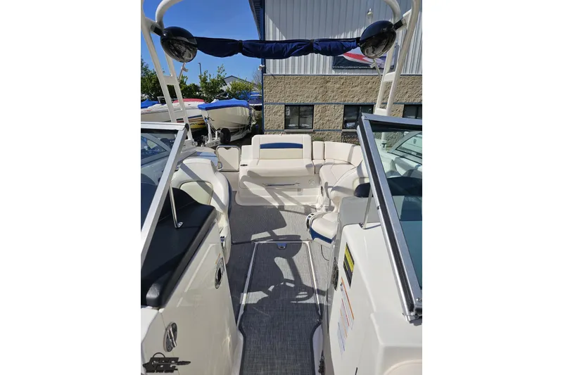 Slide: The Image of 2016 Chaparral 244 Sunesta boat interior with seating and open deck view. - 105