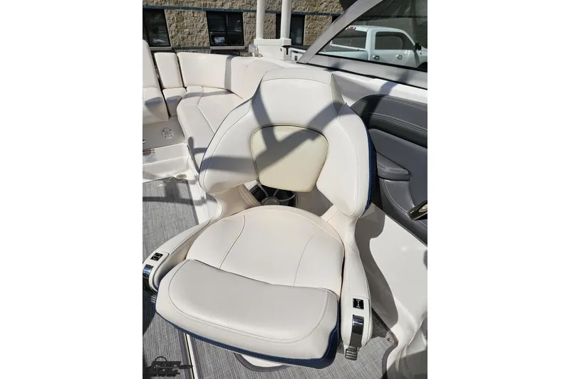 Slide: The Image of 2016 Chaparral 244 Sunesta boat interior with white cushioned seating. - 109