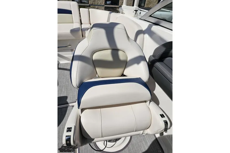 Slide: The Image of Luxury seating on 2016 Chaparral 244 Sunesta boat, featuring white and blue upholstery. - 110