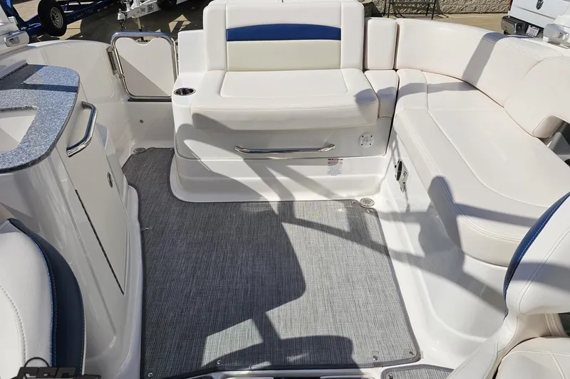 Slide: The Image of Interior of a 2016 Chaparral 244 Sunesta boat with white seating and gray flooring. - 111