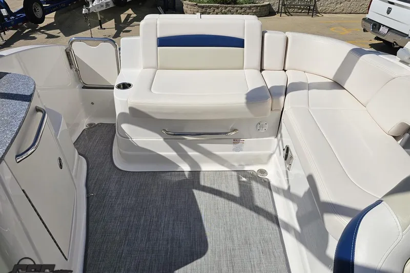 Slide: The Image of 2016 Chaparral 244 Sunesta boat interior with white seating and gray flooring. - 112