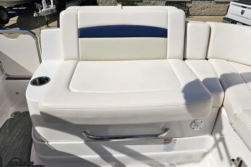 Slide: The Image of 2016 Chaparral 244 Sunesta boat seating with white upholstery and cup holder. - 113