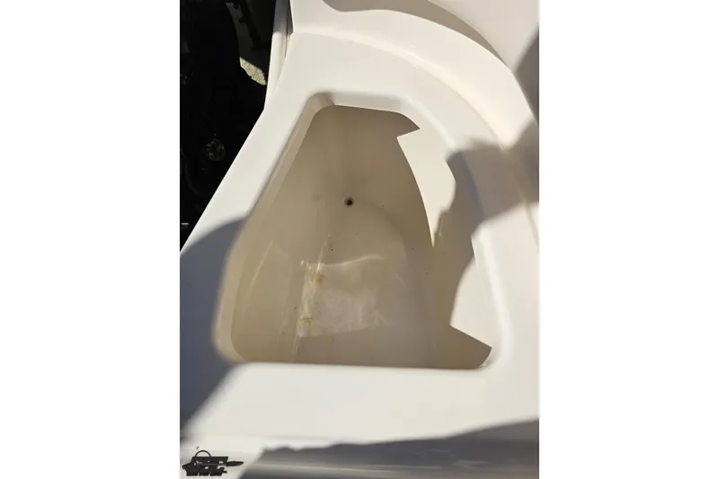 Slide: The Image of Storage compartment of 2016 Chaparral 244 Sunesta boat, featuring a clean, white interior. - 118