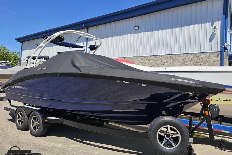 Slide: The Image of 2016 Chaparral 244 Sunesta boat on trailer, covered, parked outdoors. - 122