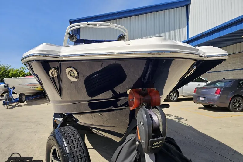 Slide: The Image of 2016 Chaparral 244 Sunesta boat on trailer, parked outdoors near a building. - 18