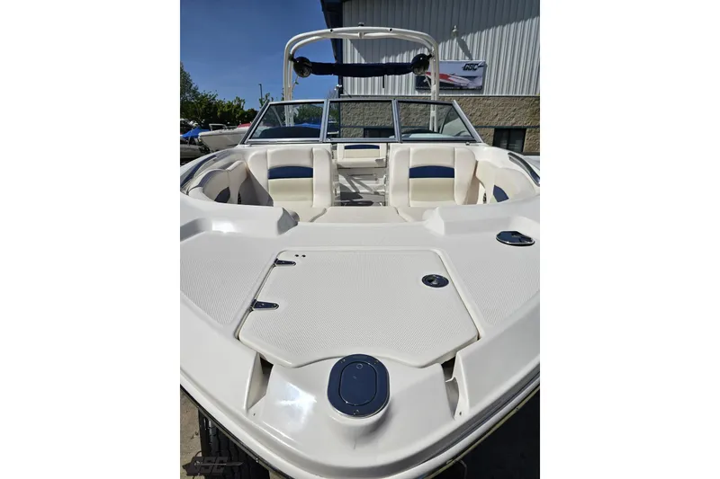 Slide: The Image of 2016 Chaparral 244 Sunesta boat interior with seating and storage compartments. - 19