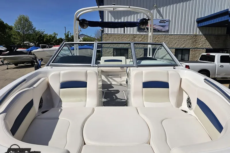 Slide: The Image of 2016 Chaparral 244 Sunesta boat with spacious seating, parked outdoors. - 20
