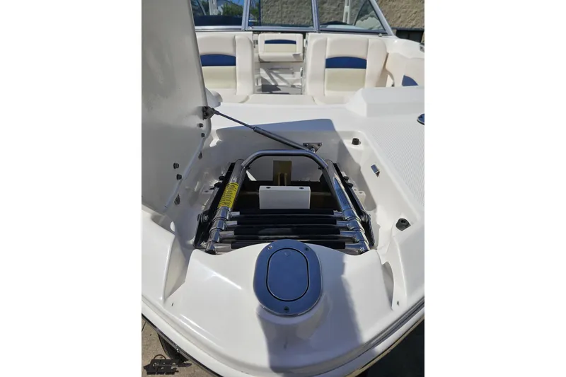 Slide: The Image of 2016 Chaparral 244 Sunesta boat interior with open storage compartment and seating. - 21