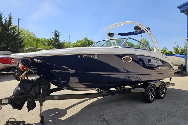 Slide: The Image of 2016 Chaparral 244 Sunesta boat on trailer, parked outdoors under clear sky. - 24