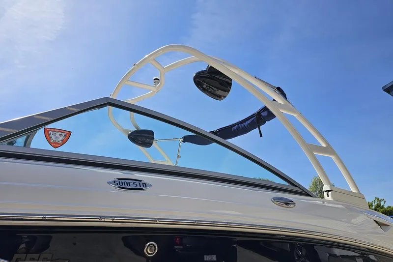 Slide: The Image of 2016 Chaparral 244 Sunesta boat with wakeboard tower against clear blue sky. - 28