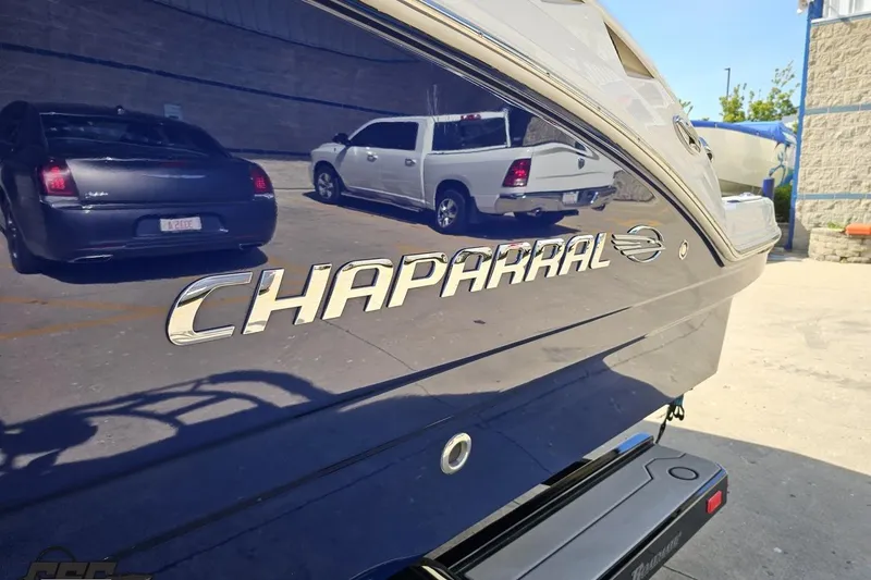 Slide: The Image of 2016 Chaparral 244 Sunesta boat with reflective surface in parking lot. - 29