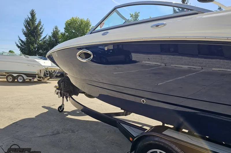 Slide: The Image of 2016 Chaparral 244 Sunesta boat on trailer in sunny outdoor setting. - 30
