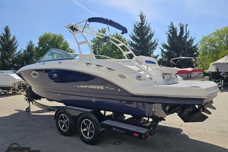 Slide: The Image of 2016 Chaparral 244 Sunesta boat on trailer, parked outdoors on a sunny day. - 32