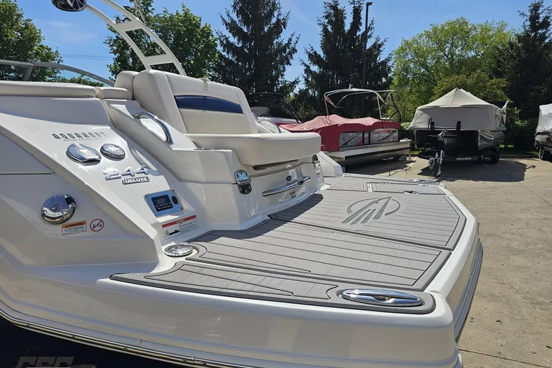 Slide: The Image of 2016 Chaparral 244 Sunesta boat with sleek deck design, parked outdoors. - 33