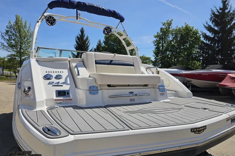 Slide: The Image of 2016 Chaparral 244 Sunesta boat with swim platform and seating, docked outdoors. - 34