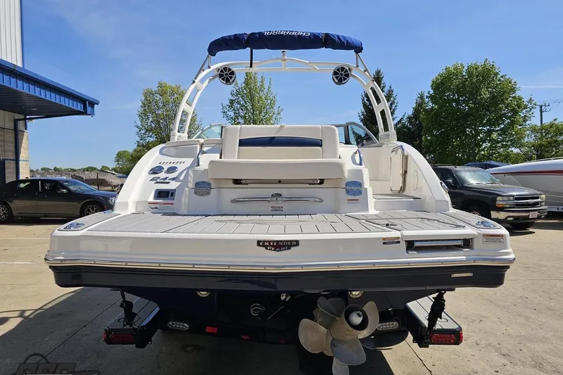 Slide: The Image of 2016 Chaparral 244 Sunesta boat, rear view, parked outdoors on a sunny day. - 36