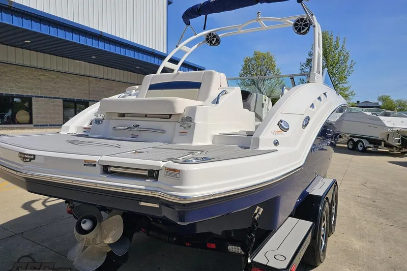 Slide: The Image of 2016 Chaparral 244 Sunesta boat on trailer, parked outdoors near a building. - 38