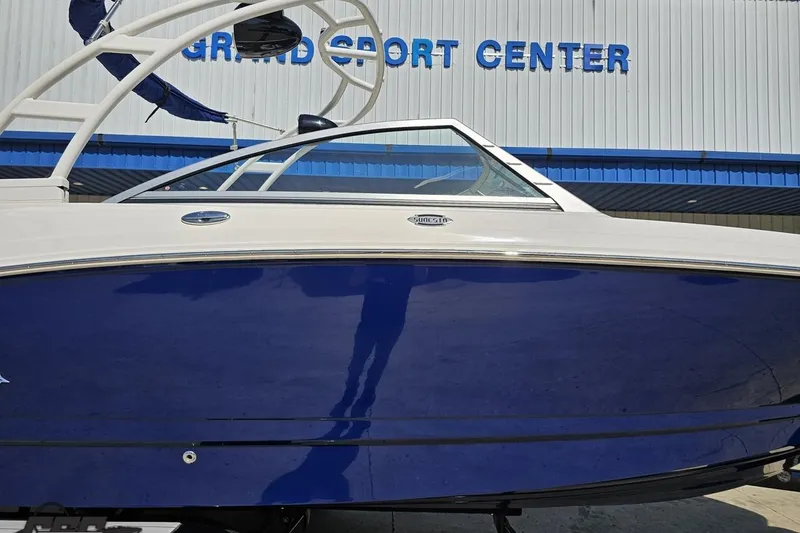 Slide: The Image of 2016 Chaparral 244 Sunesta boat with blue hull at Grand Sport Center. - 4