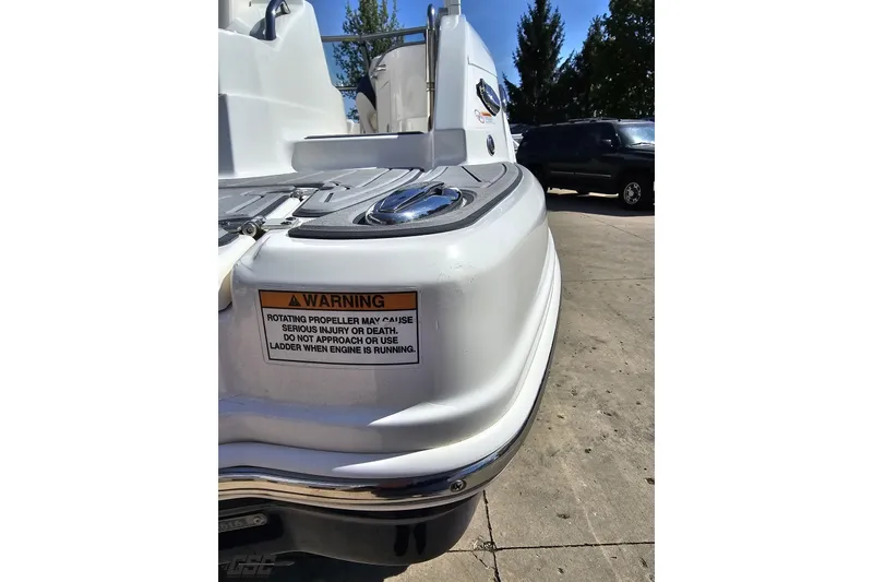 Slide: The Image of 2016 Chaparral 244 Sunesta boat stern with safety warning label. - 40
