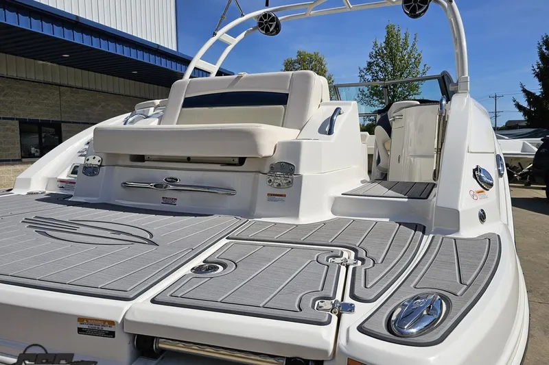 Slide: The Image of 2016 Chaparral 244 Sunesta boat with sleek design and spacious seating on a sunny day. - 41