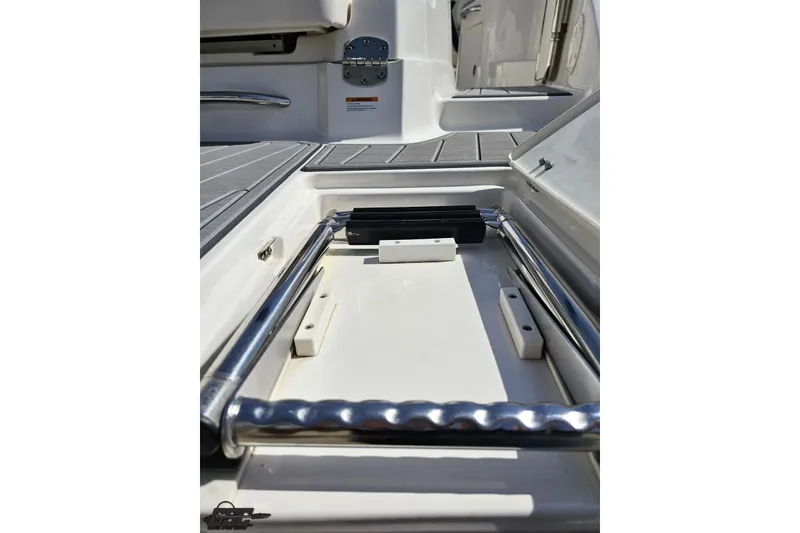 Slide: The Image of 2016 Chaparral 244 Sunesta boat ladder compartment, showcasing stainless steel details. - 42