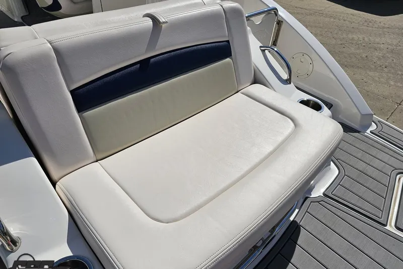 Slide: The Image of 2016 Chaparral 244 Sunesta boat seating with white upholstery and cup holders. - 46