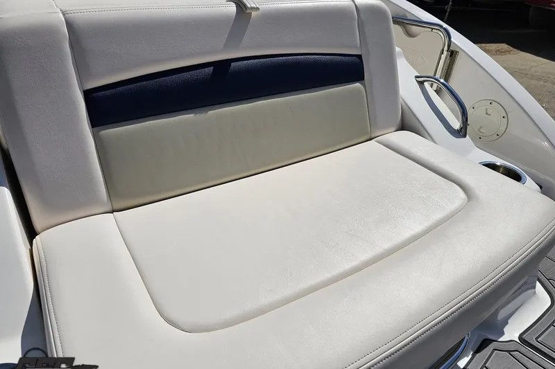 Slide: The Image of 2016 Chaparral 244 Sunesta boat seat with white and navy upholstery. - 47