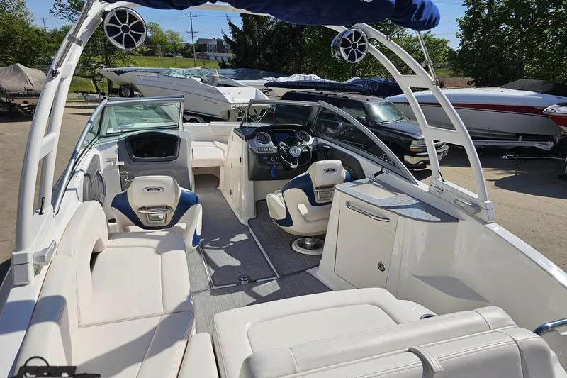 Slide: The Image of 2016 Chaparral 244 Sunesta boat interior with plush seating and modern dashboard. - 48