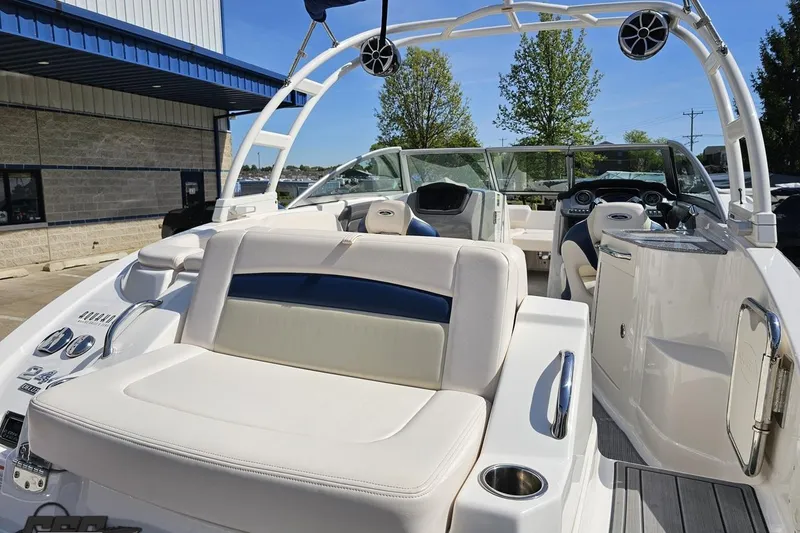 Slide: The Image of 2016 Chaparral 244 Sunesta boat interior with white seating and modern dashboard. - 50