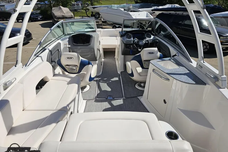 Slide: The Image of 2016 Chaparral 244 Sunesta boat interior with white seating and modern dashboard. - 53