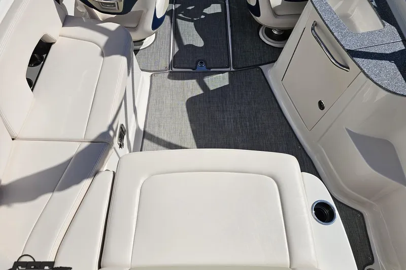 Slide: The Image of Interior view of 2016 Chaparral 244 Sunesta boat with white seating and gray flooring. - 54