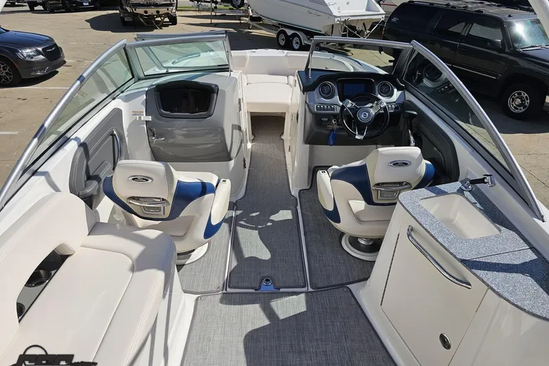 Slide: The Image of 2016 Chaparral 244 Sunesta boat interior with seating, steering, and sink. - 55