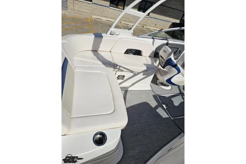 Slide: The Image of 2016 Chaparral 244 Sunesta boat interior with white seating and steering area. - 58